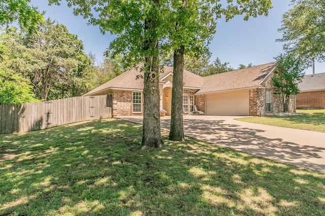 1944 Nottingham Dr, Kaufman, TX 75142 - view of front of home with a gate, a garage, fence, a front yard, and brick siding