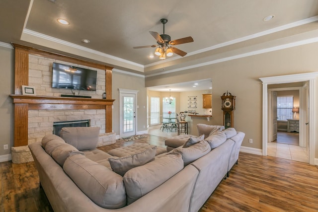 1944 Nottingham Dr, Kaufman, TX 75142 - living room with ceiling fan with notable chandelier, wood finished floors, baseboards, and ornamental molding
