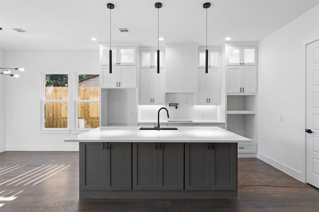 1822 Bickers St, Dallas, TX 75212 - kitchen with a sink, baseboards, a kitchen island with sink, white cabinetry, and recessed lighting