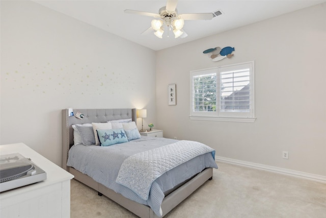 bedroom with light carpet, a ceiling fan, and baseboards