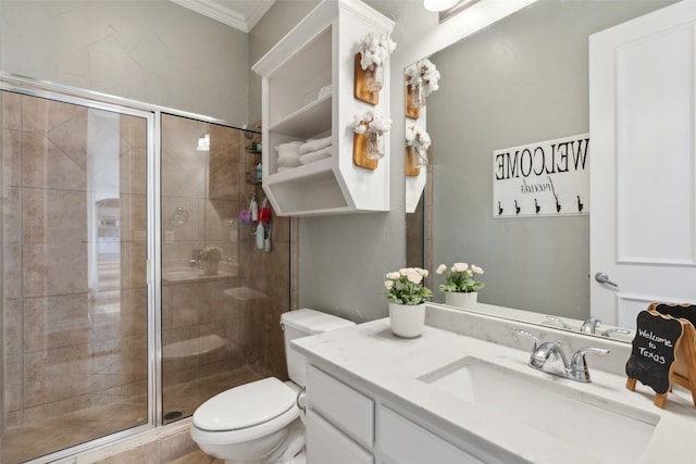 full bath featuring toilet, vanity, a shower stall, and crown molding