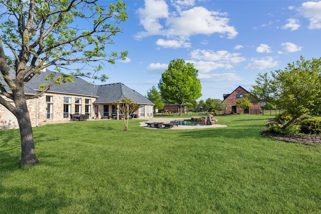 view of yard featuring a fire pit and a patio
