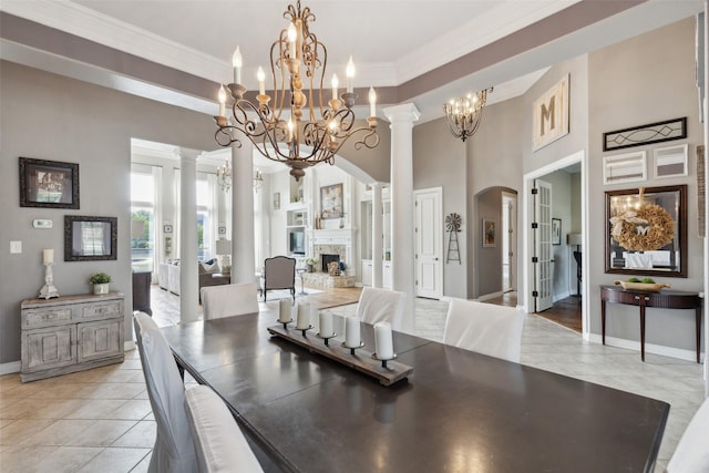 dining room featuring arched walkways, light tile patterned floors, a towering ceiling, a notable chandelier, and ornamental molding