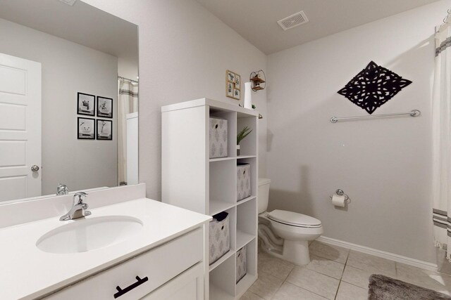 bathroom featuring vanity, baseboards, toilet, tile patterned flooring, and visible vents