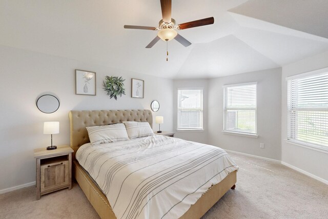 bedroom with light colored carpet, baseboards, and multiple windows