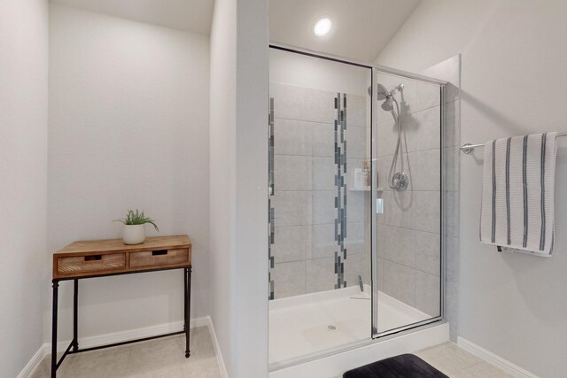 bathroom featuring a shower stall, tile patterned floors, and baseboards