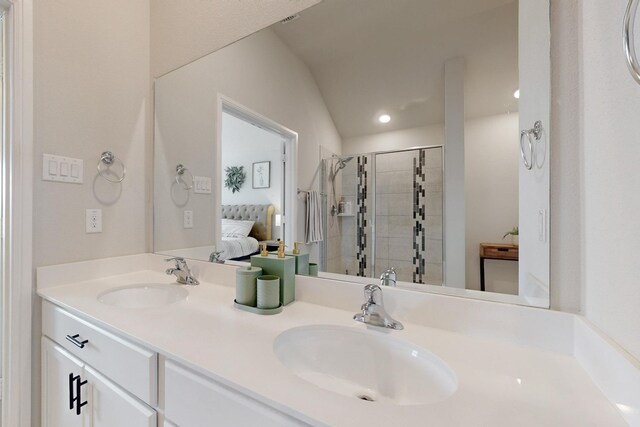 bathroom with double vanity, a sink, connected bathroom, and a stall shower