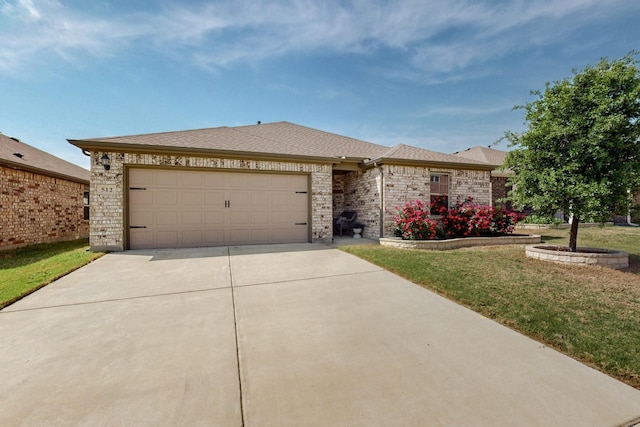 single story home featuring a garage, brick siding, a front yard, and concrete driveway