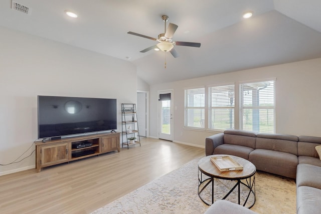 living area featuring lofted ceiling, baseboards, light wood-style flooring, and visible vents