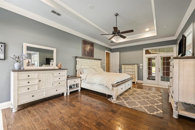bedroom featuring visible vents, ornamental molding, dark wood-type flooring, and a raised ceiling