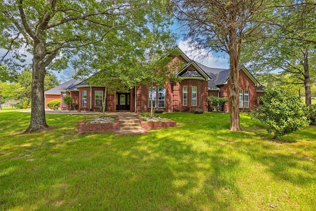 view of front facade with a front lawn and brick siding