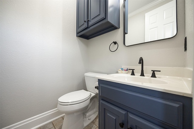 bathroom featuring crown molding, baseboards, toilet, and vanity