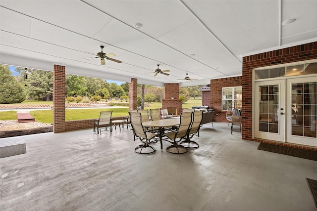 view of patio featuring french doors, outdoor dining area, and ceiling fan