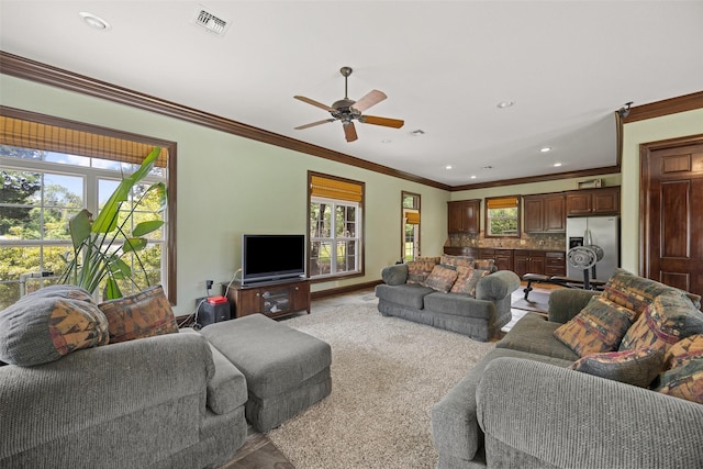 living room featuring plenty of natural light, visible vents, and ceiling fan