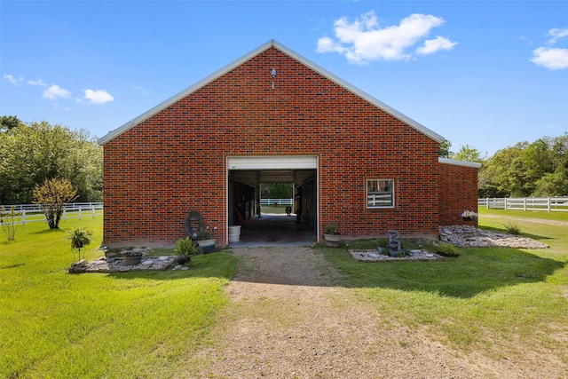 back of house with fence, dirt driveway, and a yard