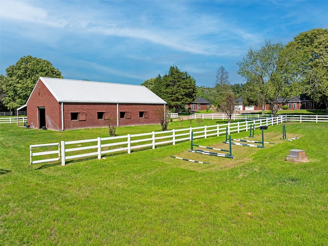 view of yard featuring fence, an outdoor structure, and a barn