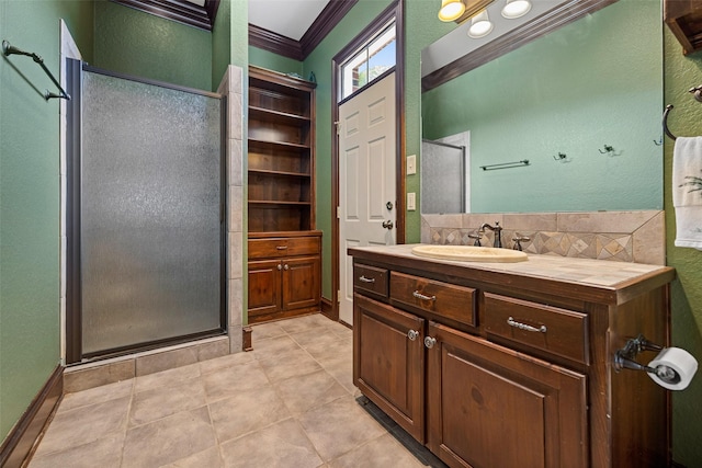 bathroom with a shower stall, tile patterned floors, vanity, a textured wall, and ornamental molding