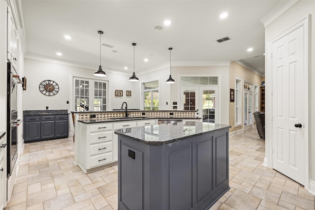 kitchen featuring a center island, stone tile floors, and recessed lighting