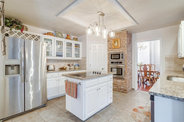 kitchen with stainless steel appliances, visible vents, light tile patterned floors, and tasteful backsplash
