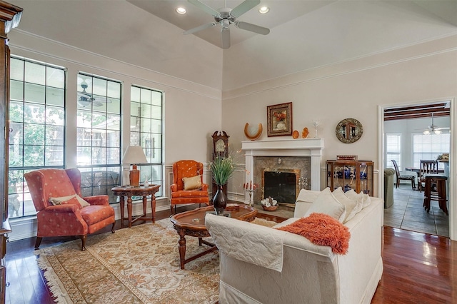 living room with wood finished floors, a high end fireplace, recessed lighting, and ceiling fan