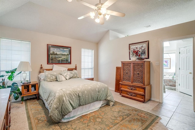 bedroom with baseboards, vaulted ceiling, visible vents, and a ceiling fan