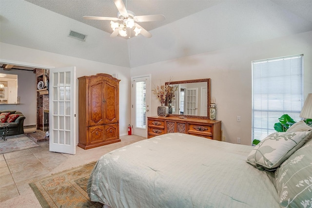 bedroom featuring lofted ceiling, visible vents, and ceiling fan