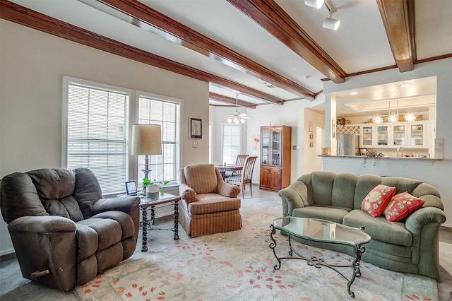 living room with ceiling fan with notable chandelier and beam ceiling