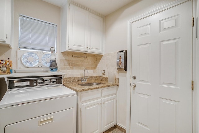 washroom featuring a sink, washer / clothes dryer, and cabinet space