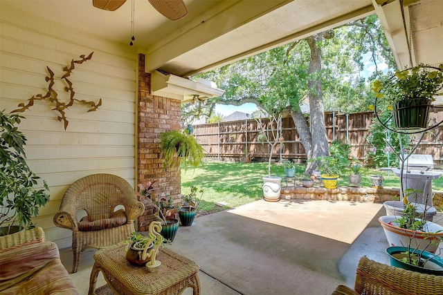 view of patio featuring fence, a ceiling fan, and area for grilling