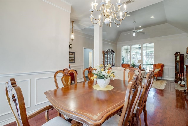 dining space with a decorative wall, a wainscoted wall, wood finished floors, and ceiling fan with notable chandelier