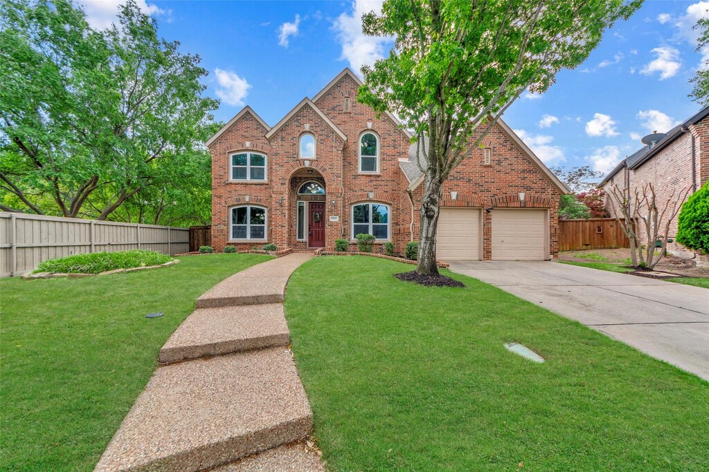 8401 Persimmon Ct, Mckinney, TX 75072 - traditional home with driveway, an attached garage, fence, a front yard, and brick siding