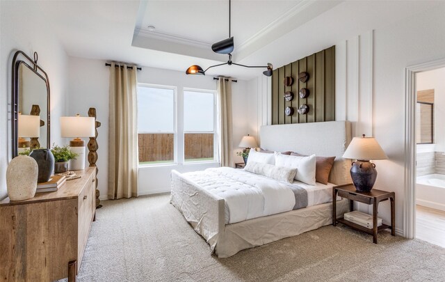 bedroom with light carpet, baseboards, a tray ceiling, and crown molding