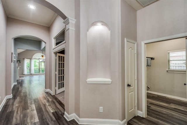 604 Lake Village Dr, Mckinney, TX 75071 - corridor with arched walkways, dark wood finished floors, baseboards, and crown molding
