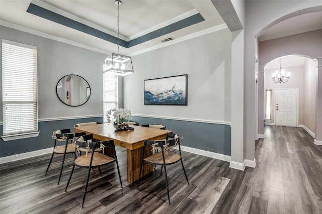 604 Lake Village Dr, Mckinney, TX 75071 - dining area with a chandelier, arched walkways, dark wood finished floors, decorative columns, and baseboards