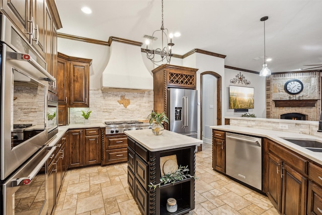 kitchen with light countertops, stainless steel appliances, crown molding, and custom range hood