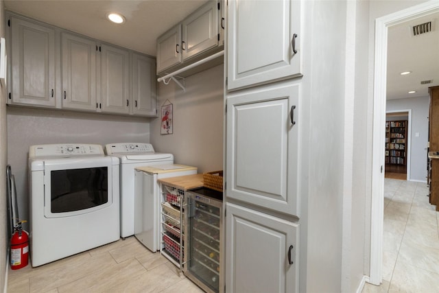 129 Highland Dr, Aledo, TX 76008 - laundry room with cabinet space, visible vents, washer and clothes dryer, and wine cooler