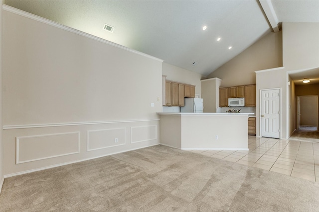 interior space featuring high vaulted ceiling, wainscoting, light tile patterned flooring, light colored carpet, and beam ceiling