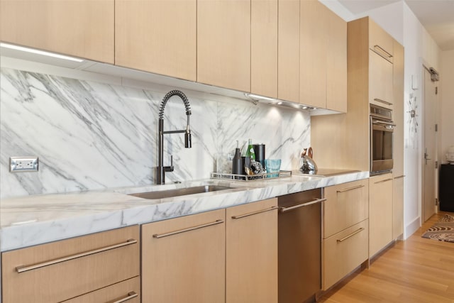 2200 Victory Ave Unit 2003, Dallas, TX 75219 - kitchen featuring a sink, appliances with stainless steel finishes, and light brown cabinets