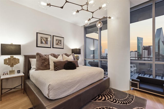 2200 Victory Ave Unit 2003, Dallas, TX 75219 - bedroom with a chandelier and wood finished floors