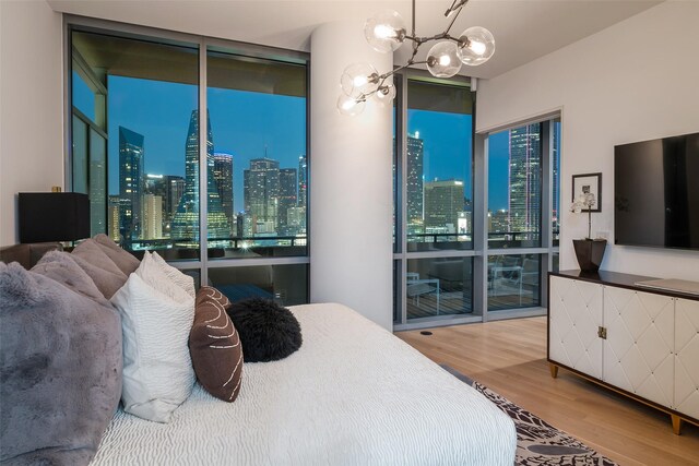 2200 Victory Ave Unit 2003, Dallas, TX 75219 - bedroom with wood finished floors, floor to ceiling windows, and a chandelier