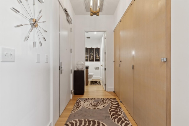 2200 Victory Ave Unit 2003, Dallas, TX 75219 - hall featuring a chandelier and light wood-style floors