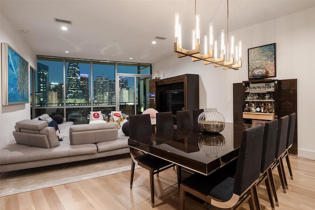 2200 Victory Ave Unit 2003, Dallas, TX 75219 - dining area with light wood-type flooring, a chandelier, expansive windows, and recessed lighting