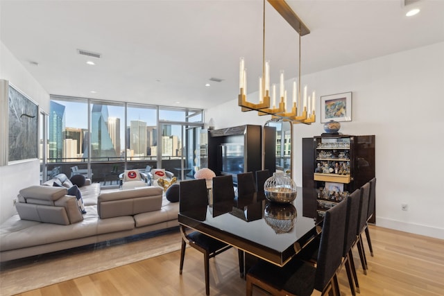 2200 Victory Ave Unit 2003, Dallas, TX 75219 - dining room featuring light wood finished floors, healthy amount of natural light, a view of city, baseboards, and recessed lighting