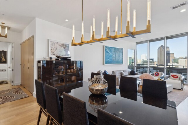 2200 Victory Ave Unit 2003, Dallas, TX 75219 - dining room featuring wood finished floors, a view of skyline, and expansive windows