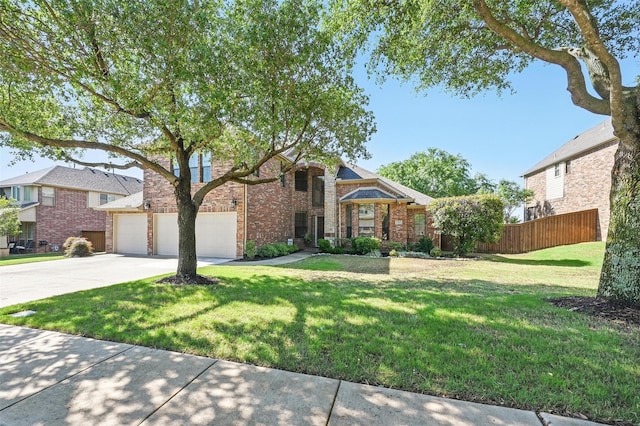 view of front of house with concrete driveway, fence, a front yard, a garage, and brick siding