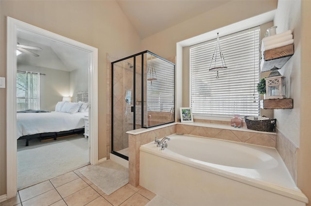 full bathroom with a shower stall, a garden tub, ensuite bath, lofted ceiling, and tile patterned flooring