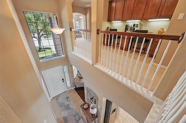 doorway to outside with a towering ceiling and arched walkways