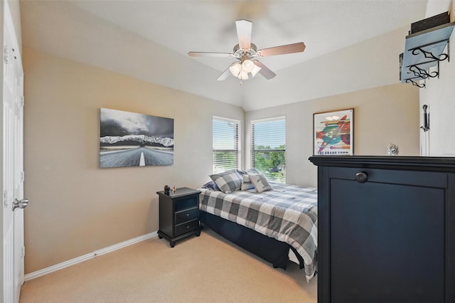 bedroom featuring light colored carpet, ceiling fan, and baseboards