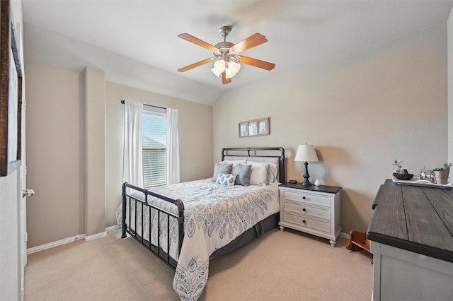 bedroom featuring ceiling fan, light carpet, lofted ceiling, and baseboards