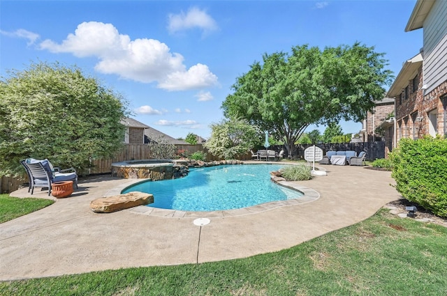 view of pool with a patio area, a pool with connected hot tub, and a fenced backyard